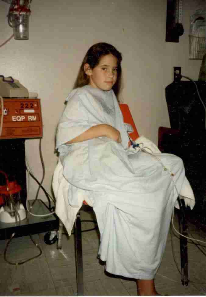 Jenny with Dad A photo of Jenny in a hospital bed before her first surgery at age 9
