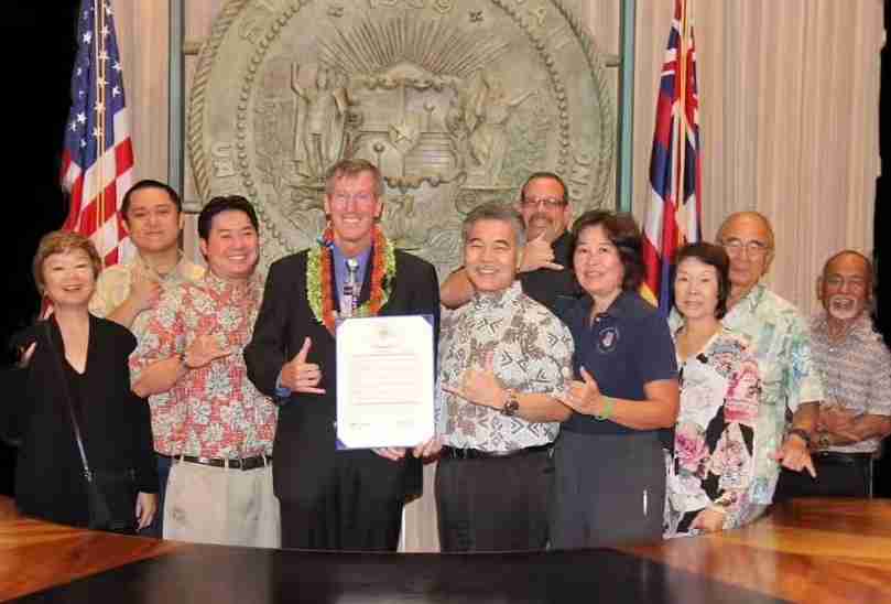 Dan smiles in front of a group as they succeeded in designating a proclamation day in Hawaii for FAP