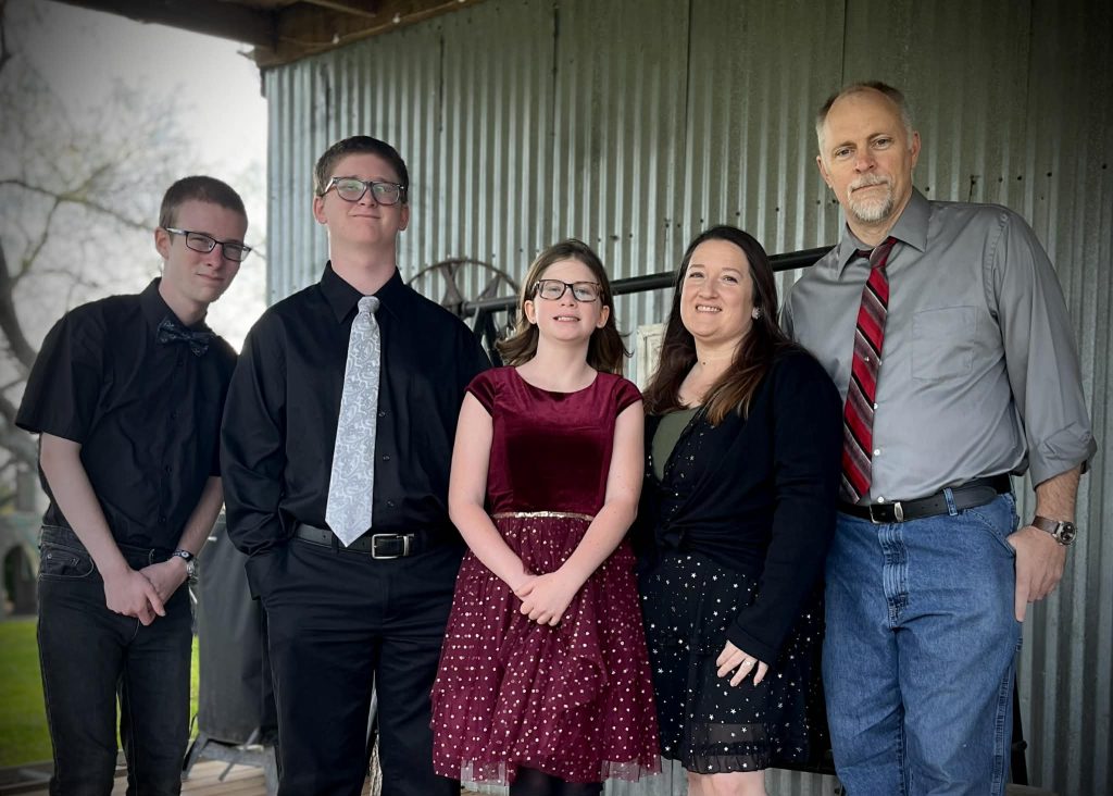 The Tiffany family smiles and poses for a family photo